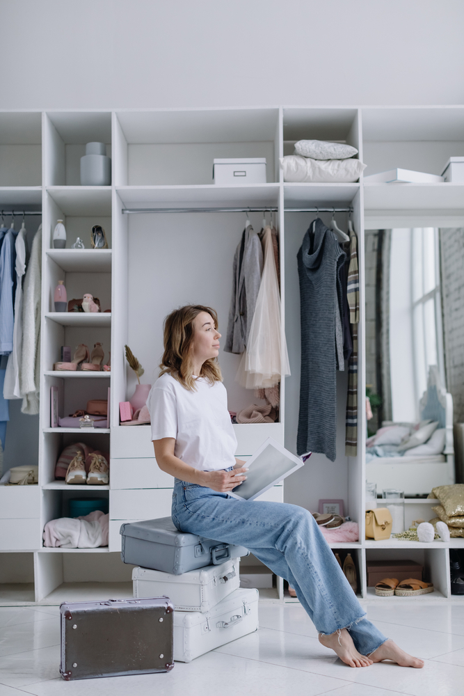 Stylish,Young,Female,Fashion,Designer,Dreaming,Sitting,Near,Wardrobe,With