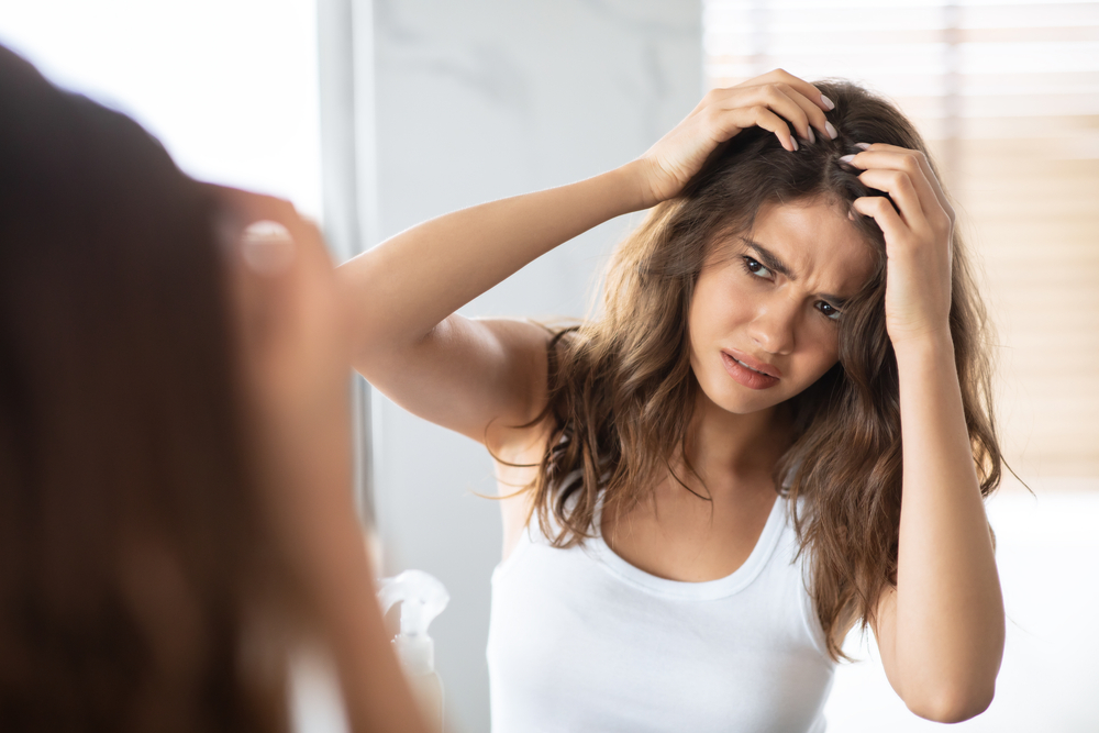 Unhappy,Woman,Looking,At,Hair,Flakes,Having,Dandruff,Problem,Indoor