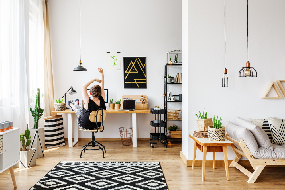 Young,Creative,Artist,Working,At,Desk,In,Her,Cozy,Apartment