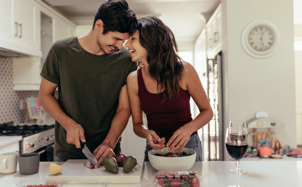Loving,Young,Couple,Cutting,Vegetables,Together,At,Kitchen,Counter.,Young