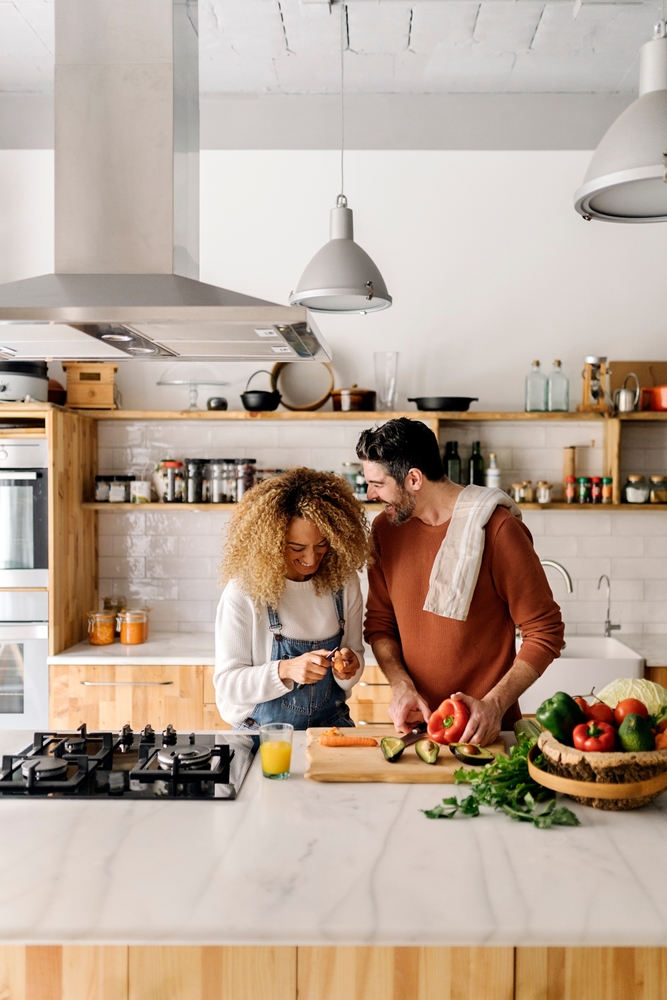 Couple,Preparing,Food,In,Kitchen.