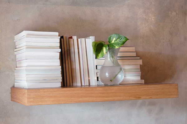 Stack,Of,Books,On,Floating,Wooden,Bookshelf.,Education,And,Knowledge
