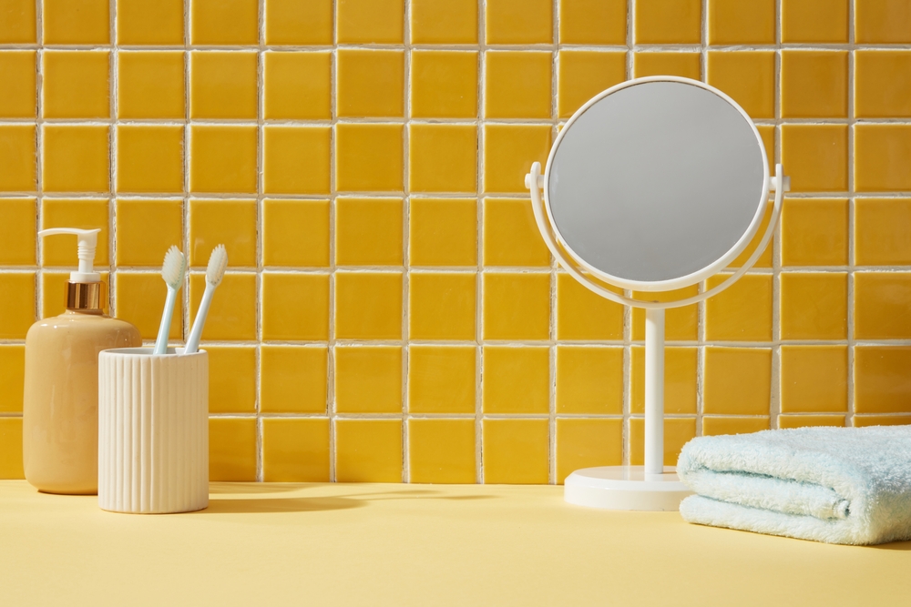 A,Mirror,,Towel,And,Toothbrushes,Inside,A,Bathroom,Background.,Front