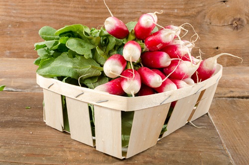Bunch,Of,Radishes,In,A,Basket,On,Wooden,Background
