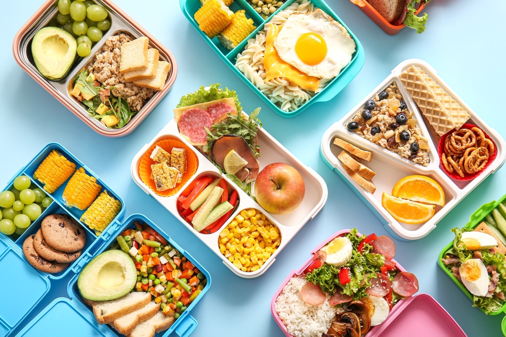 Many,Lunchboxes,With,Different,Delicious,Food,On,Blue,Background